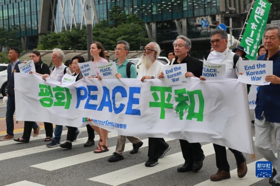 7月22日，在韓國首爾，人們手舉標語參與反戰(zhàn)游行。新華社發(fā)（楊暢 攝）