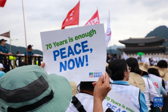 7月22日，在韓國首爾，人們手舉標語參與反戰(zhàn)游行。新華社發(fā)（楊暢 攝）